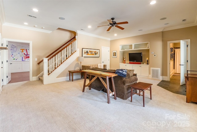 carpeted living area featuring visible vents, recessed lighting, crown molding, ceiling fan, and stairs