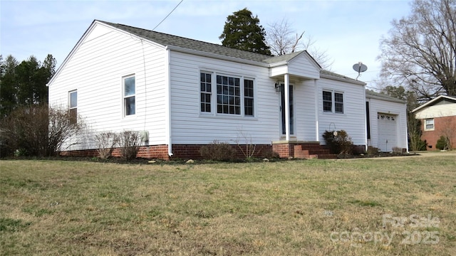 view of front of property with entry steps, a front yard, and a garage