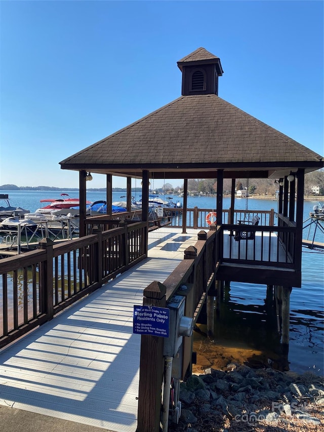 view of dock featuring a water view and a gazebo