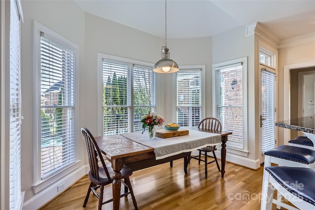 dining area with baseboards and light wood-style floors