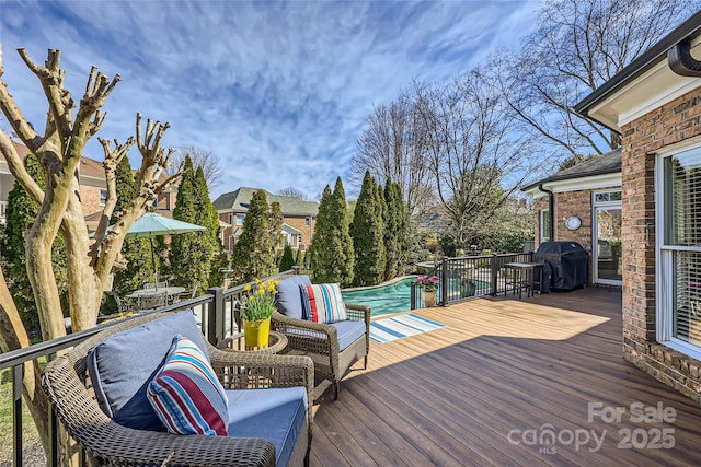 wooden deck featuring an outdoor pool, grilling area, and an outdoor living space