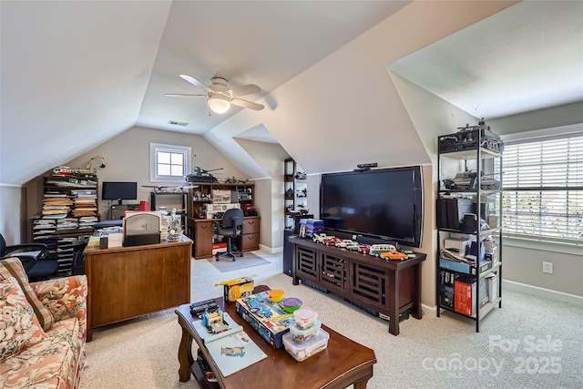 living area featuring vaulted ceiling, ceiling fan, carpet flooring, and baseboards