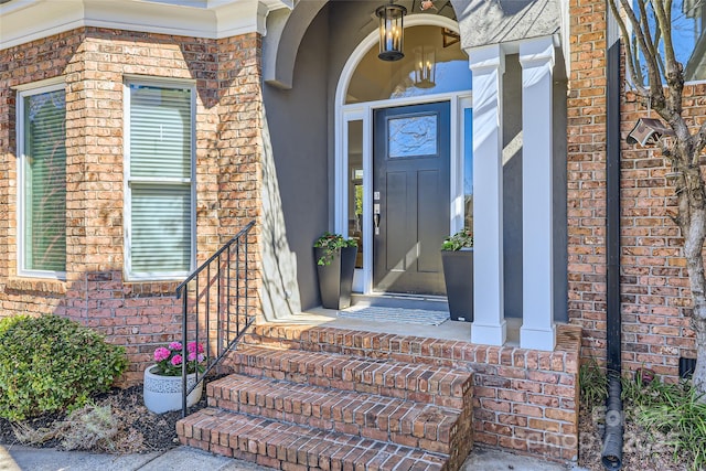 doorway to property with brick siding