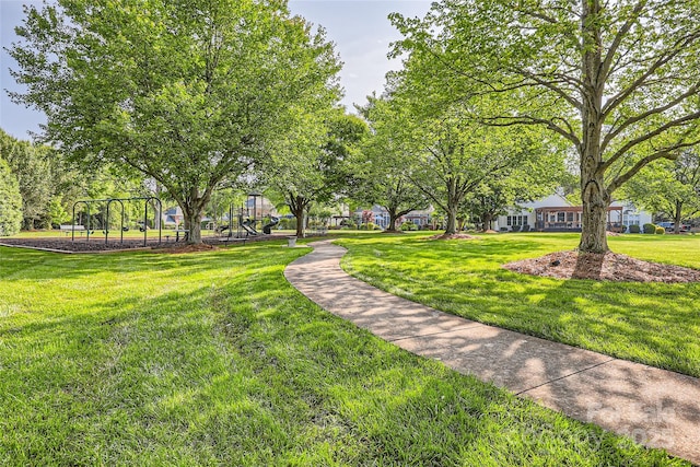 view of community with playground community and a yard