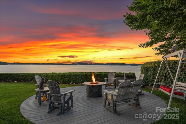 deck with a yard and an outdoor fire pit