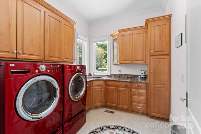 clothes washing area featuring washing machine and clothes dryer, visible vents, crown molding, light tile patterned flooring, and cabinet space