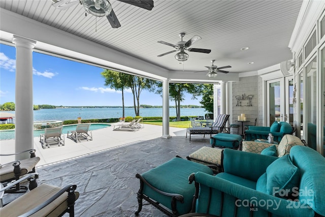 view of patio featuring an outdoor pool and a water view