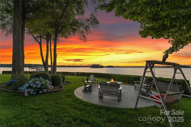 view of yard with a deck with water view