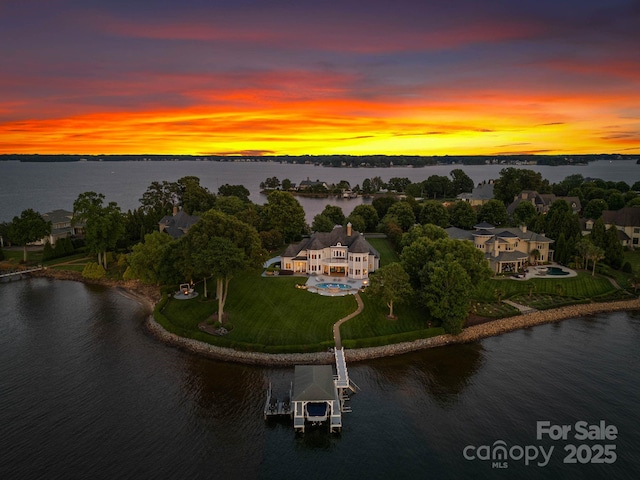 aerial view at dusk with a water view