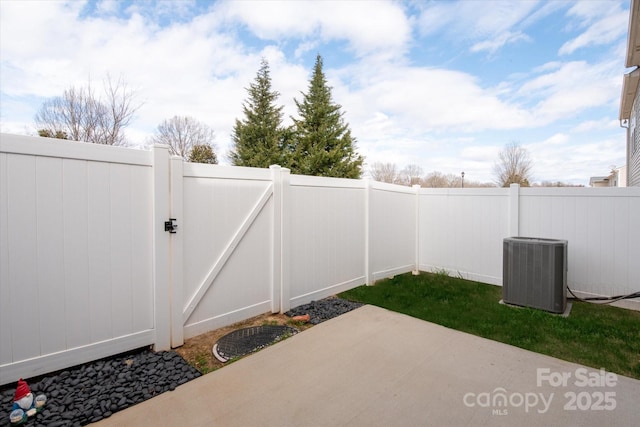 view of patio with a gate, a fenced backyard, and central AC unit