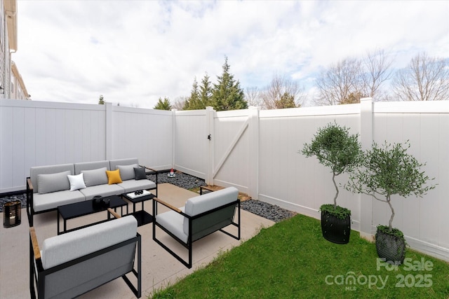 view of patio with an outdoor hangout area, a fenced backyard, and a gate