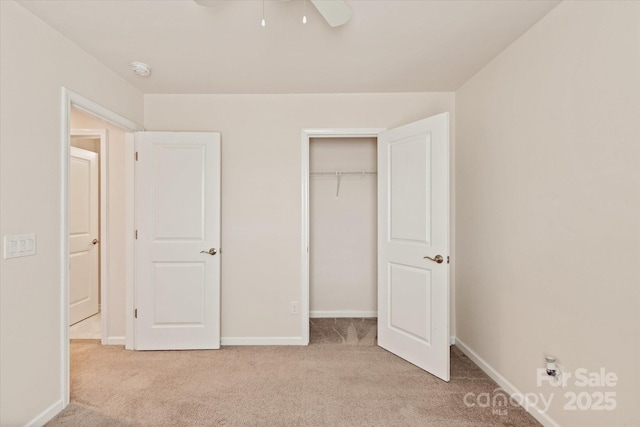 unfurnished bedroom featuring a ceiling fan, a closet, carpet flooring, and baseboards