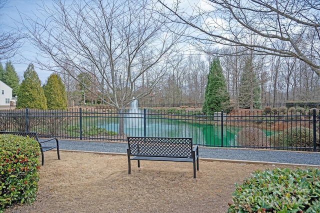 view of home's community featuring fence