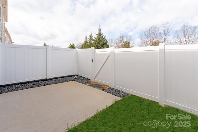 view of patio / terrace with a fenced backyard and a gate