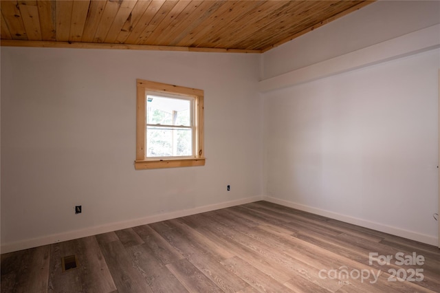 unfurnished room featuring lofted ceiling, wood ceiling, baseboards, and wood finished floors