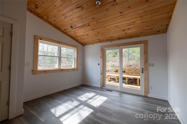 spare room featuring a healthy amount of sunlight, wooden ceiling, vaulted ceiling, and wood finished floors