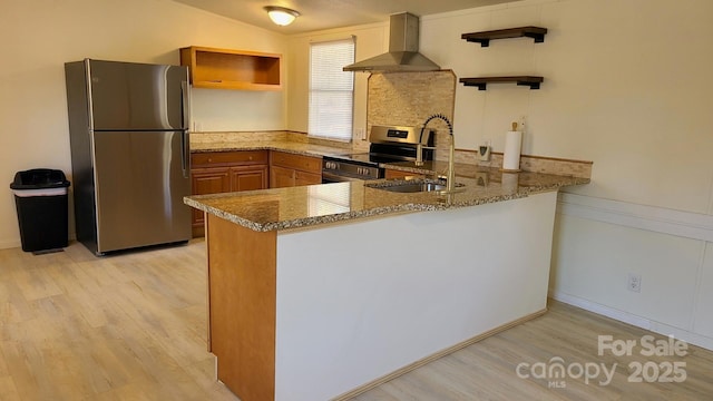 kitchen featuring a peninsula, stone counters, stainless steel appliances, wall chimney range hood, and open shelves