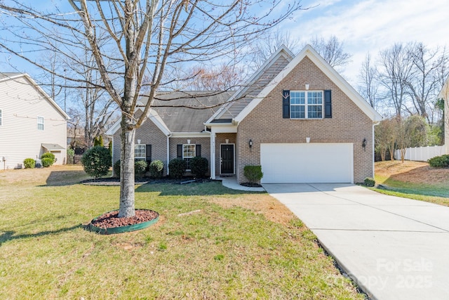 traditional home with a garage, concrete driveway, fence, a front yard, and brick siding