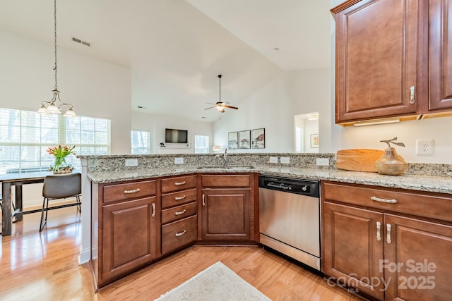 kitchen with light wood-style floors, visible vents, dishwasher, and a sink