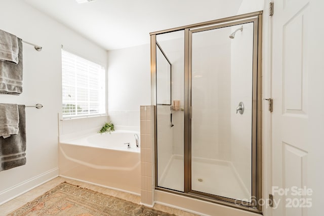 full bath featuring tile patterned flooring, a shower stall, and a bath