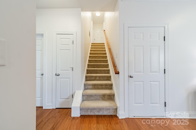 stairway with wood finished floors