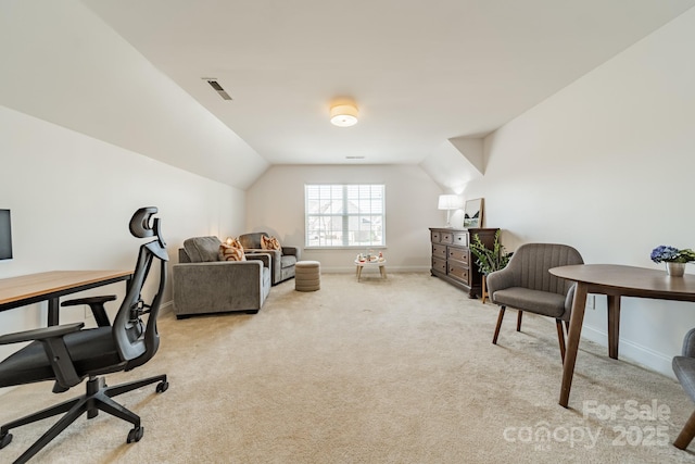 office area featuring light carpet, baseboards, visible vents, and vaulted ceiling