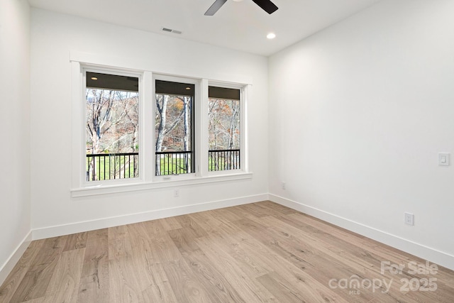 unfurnished room featuring recessed lighting, visible vents, light wood-style flooring, and baseboards