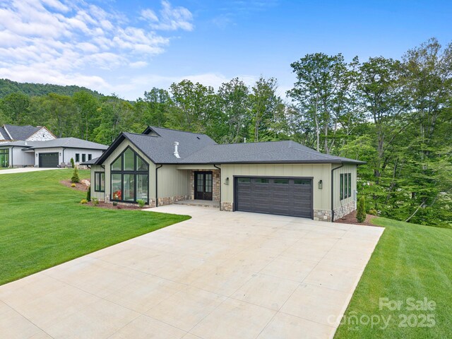 90 Bridgeway Dr Unit 25, Candler, NC 28715 - view of front of property with a garage, a front lawn, driveway, and a shingled roof