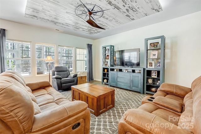 living room featuring wood ceiling, plenty of natural light, light carpet, and ceiling fan