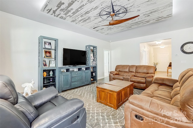 living area with a ceiling fan