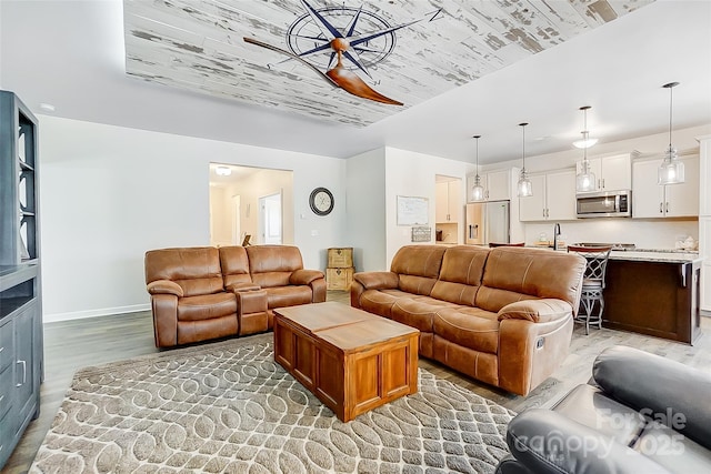 living area with light wood finished floors and baseboards