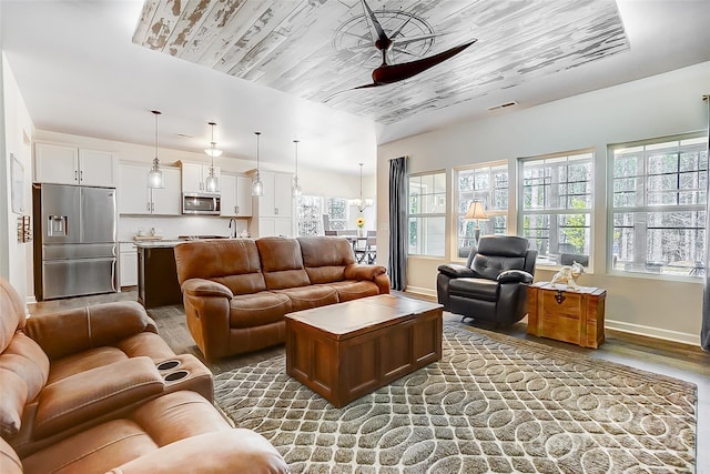 living room with visible vents, a ceiling fan, wood ceiling, wood finished floors, and baseboards