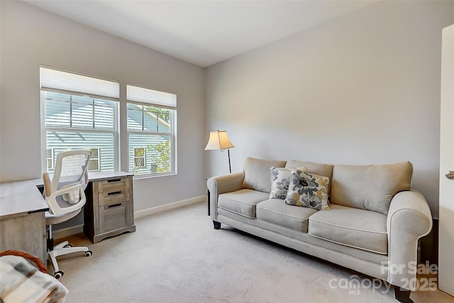 office space featuring baseboards and light colored carpet