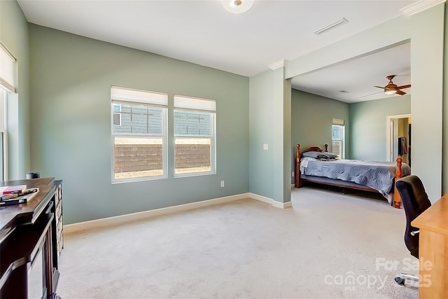 bedroom featuring light colored carpet, visible vents, and baseboards