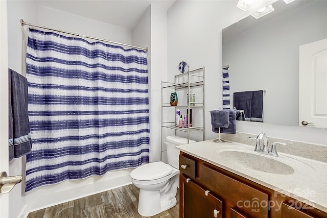 bathroom with shower / bath combo, vanity, toilet, and wood finished floors