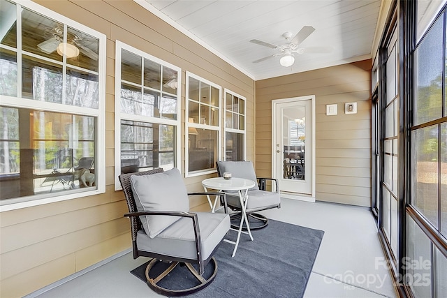 sunroom / solarium featuring ceiling fan