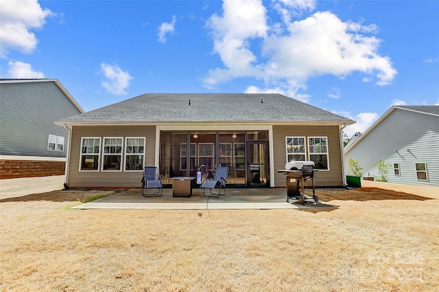 back of house featuring a shingled roof and a patio