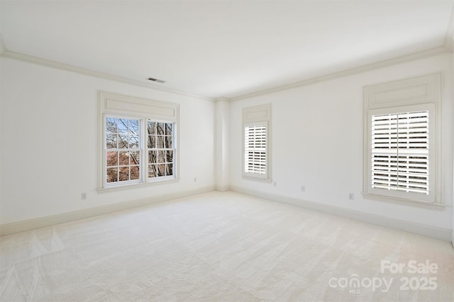 unfurnished room with light carpet, ornamental molding, visible vents, and baseboards