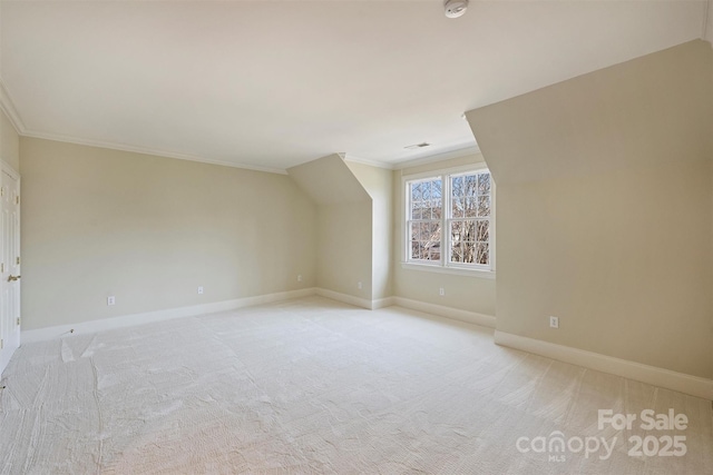 additional living space with light colored carpet, visible vents, and baseboards