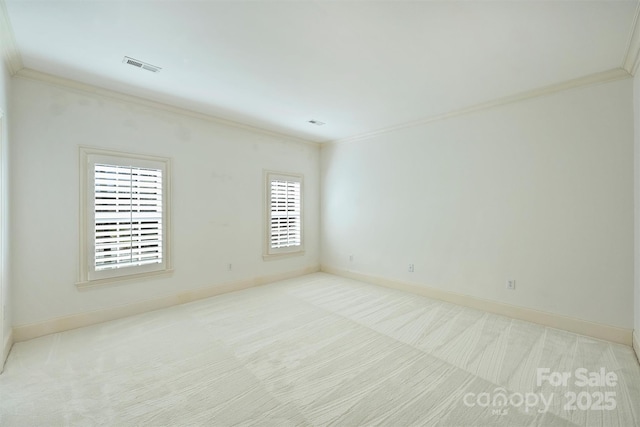 empty room with ornamental molding, carpet, and visible vents