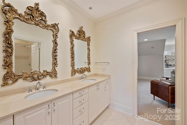 full bath featuring double vanity, ornamental molding, tile patterned flooring, and a sink