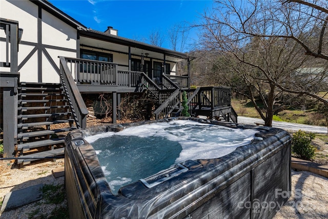 exterior space with a hot tub and stairs