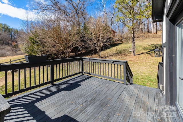 wooden deck featuring a yard