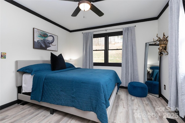 bedroom featuring baseboards, visible vents, ceiling fan, wood finished floors, and crown molding