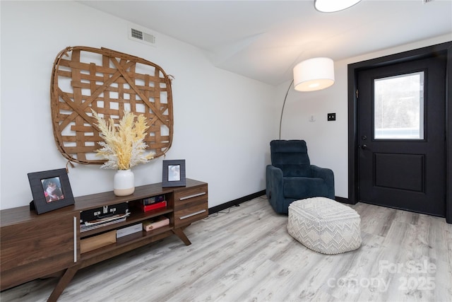 entrance foyer with baseboards, visible vents, and light wood-style floors