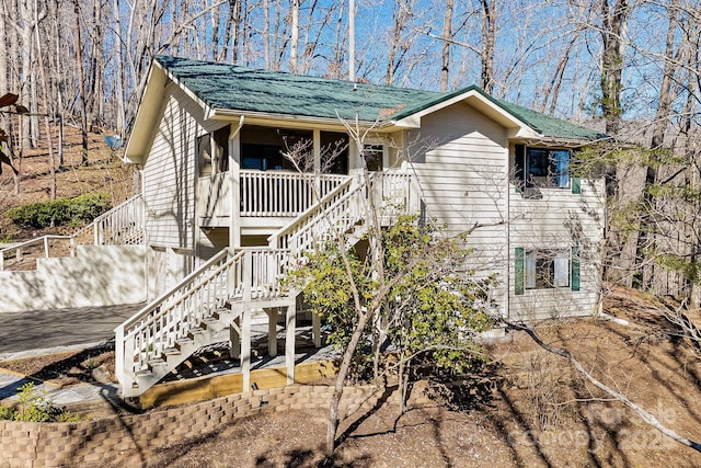 rear view of property featuring stairway