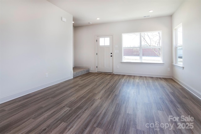 entryway featuring visible vents, baseboards, and dark wood finished floors