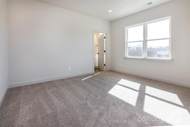 spare room featuring recessed lighting, carpet flooring, visible vents, and baseboards