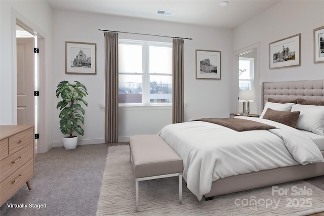 bedroom with light carpet, baseboards, and visible vents