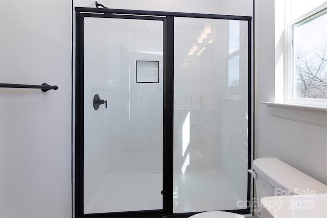 full bathroom with a shower stall and toilet